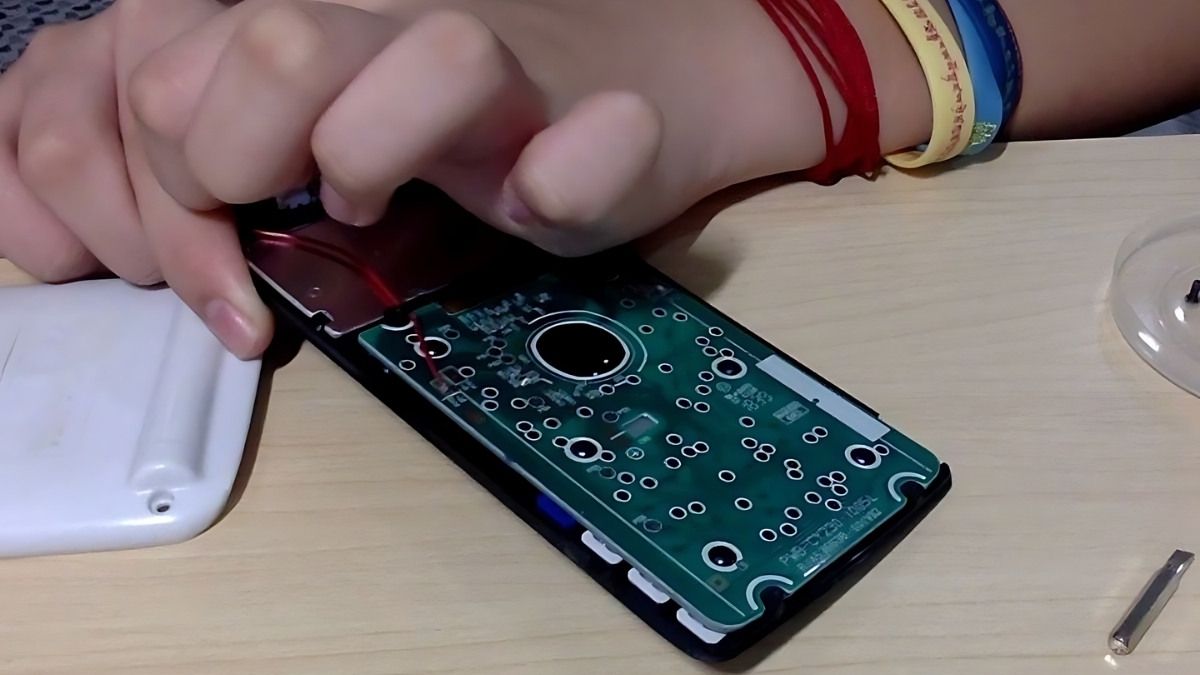 Đặt viên pin mới vào khay chứa