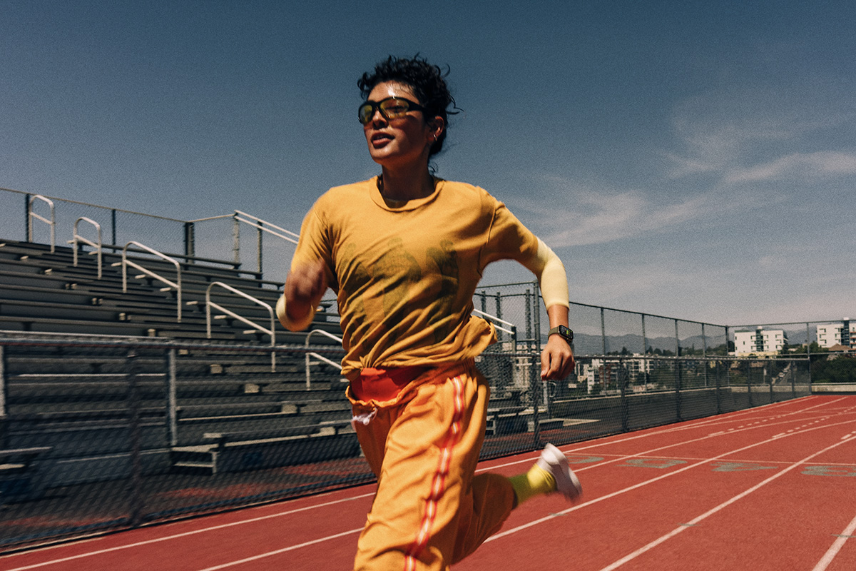An Apple Watch Series 12 user is pictured running on a track.
